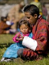 Girl gets fruit from her father at a festival