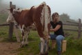 Girl gets natural milk on a farm in the carpathian mountains