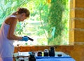 Girl gets pattern on the fabric paint in a rural workshop