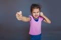 Girl getting angry fist shows on a gray background Royalty Free Stock Photo