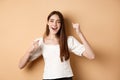 Girl getting motivation, making fist pumps and chanting yes, smiling happy, celebrating victory or cheering, standing on Royalty Free Stock Photo