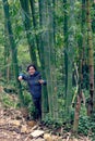 Girl between bamboo stalks