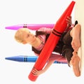 Girl with giant crayons Royalty Free Stock Photo
