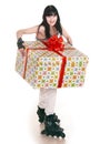 Girl with gift box go skating. Royalty Free Stock Photo