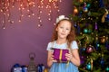 Girl with gift box near christmas tree Royalty Free Stock Photo