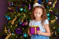 Girl with gift box near christmas tree Royalty Free Stock Photo