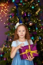 Girl with gift box near christmas tree Royalty Free Stock Photo