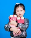 Girl with gift boxes blue background. Black friday. Shopping day. Child carry lot gift boxes. Surprise gift box Royalty Free Stock Photo