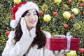 Girl with a gift near christmas tree Royalty Free Stock Photo