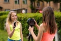 2 girl girlfriend in summer in a park on nature. Records the video on the camera, talks about the new phone. The concept