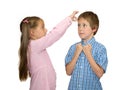 Girl gives a flick on boy's forehead, on white Royalty Free Stock Photo