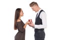 A girl gives her boyfriend a gift box, the guy takes a present. Valentine`s Day. Isolated. Royalty Free Stock Photo