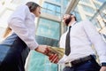 A girl gives a man in the hands of money in the background of an office building. Payment for services. Salary in the envelope.