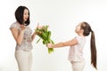 The girl gives to mother a bouquet