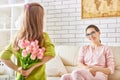 Girl giving a bouquet to mother