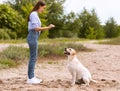 Girl giving a command to her obedient dog Royalty Free Stock Photo