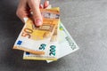 Girl giving euros, selective focus. Detail of woman hands with euro money, Euro currency offering , euro bills. charity. gray Royalty Free Stock Photo