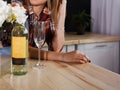 Girl with a glass and a bottle of white wine. Royalty Free Stock Photo