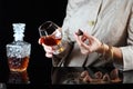 Girl with a glass of cognac and candy Royalty Free Stock Photo