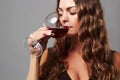 Girl with glass of red wine.Beautiful blond woman drinking red wine