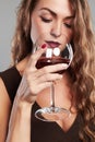 Girl with glass of red wine.Beautiful blond woman drinking red wine