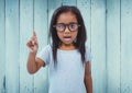 Girl with glasses against blue wood panel Royalty Free Stock Photo