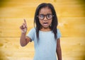 Girl in glasses against yellow wood panel Royalty Free Stock Photo