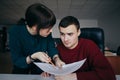 Girl with glasses explaining something to the guy and the guy does not understand