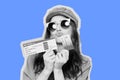 A girl with glasses in front of her hands holds airline tickets and credit cards Royalty Free Stock Photo