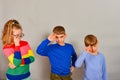 The girl with glasses and her two younger brothers show their respect and love for their sister Royalty Free Stock Photo