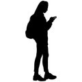 Girl in glasses with long hair, in pants, in boots, with backpack and phone