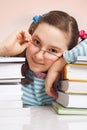 Girl with glasses and a lot of books Royalty Free Stock Photo