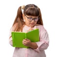 Girl in glasses with a notebook in hand. a student in a pink shirt writes with a pen .