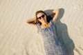 Girl with glasses is relaxing by laying down on the beach. top view Royalty Free Stock Photo