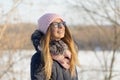 Girl with glasses in the winter on the nature enjoys the sun.