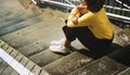 Girl with Glasses Yellow Sweater Sitting on the Stairs Concept Royalty Free Stock Photo