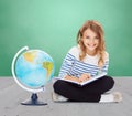 Girl with globe and book Royalty Free Stock Photo