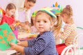 Girl glue paper in crafting kindergarten Royalty Free Stock Photo