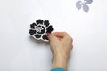 The girl glues the cut out elements from self-adhesive paper, to mask the defects of the white door. Royalty Free Stock Photo