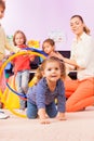 Girl go though hoops playing game in kindergarten Royalty Free Stock Photo