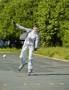 A girl goes on roller skates,trying to maintain balance