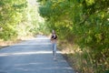 Girl goes in for sports runs on a forest road