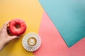 The girl is going to drink coffee and eat donut which lie on the colored surface Royalty Free Stock Photo