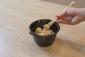 A girl is going to eat in a Chinese food, they eating with chopsticks, close-up on hands and food Royalty Free Stock Photo