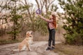 Girl with golden retriever dog in the wood Royalty Free Stock Photo