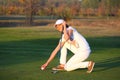 Girl golf player on field Royalty Free Stock Photo