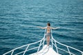 Girl with good body stay on rostrum in open sea Royalty Free Stock Photo