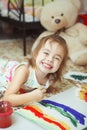 Girl of good mood painting rainbow with brush