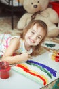 Girl of good mood painting rainbow with brush