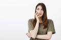 Girl got interesting idea, wanting to fullfill it. Portrait of focused intrigued good-looking woman with brown hair Royalty Free Stock Photo